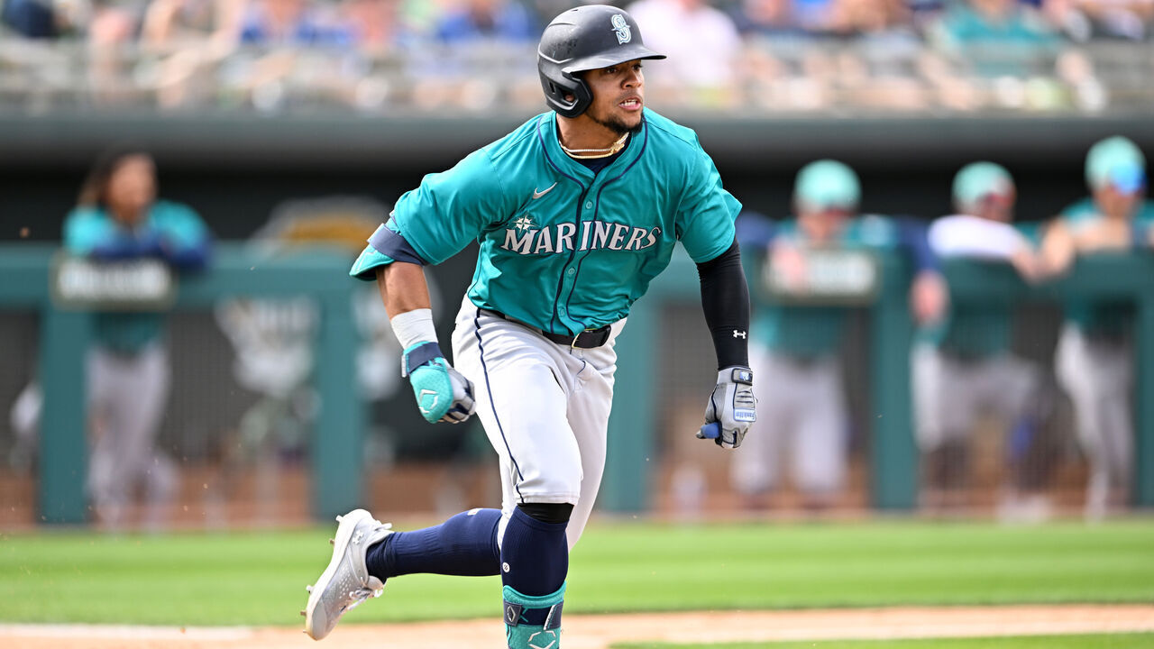 MESA, ARIZONA - MARCH 12, 2024: Jonatan Clase #85 of the Seattle Mariners runs out a bunt single during the seventh inning of a spring training game against the Oakland Athletics at Hohokam Stadium on March 12, 2024 in Mesa, Arizona.