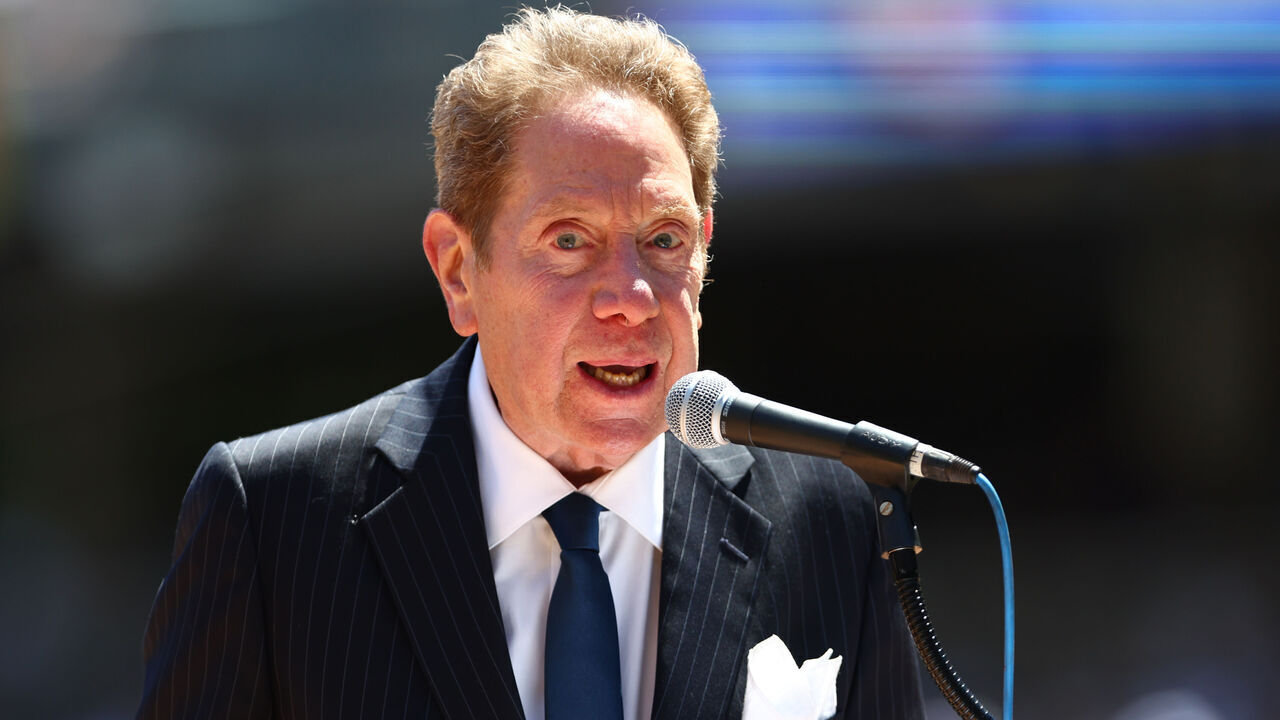 NEW YORK, NY - JULY 30: New York Yankees radio broadcaster John Sterling emcees the Old Timers Day Ceremony before a game between the Kansas City Royals and New York Yankees at Yankee Stadium on July 30, 2022 in New York City.