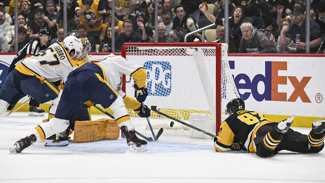 PITTSBURGH, PA - APRIL 15: Pittsburgh Penguins center Sidney Crosby (87) scores a goal against Nashville Predators goaltender Juuse Saros (74) during the first period in the NHL game between the Pittsburgh Penguins and the Nashville Predators on April 15, 2024, at PPG Paints Arena in Pittsburgh, PA.