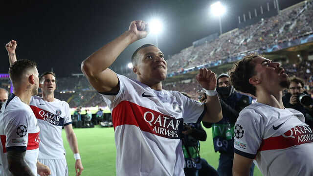 Paris Saint-Germain's French forward #07 Kylian Mbappe celebrates with teammates scoring his team's third goal from the penalty spot during the UEFA Champions League quarter-final second leg football match between FC Barcelona and Paris SG at the Estadi Olimpic Lluis Companys in Barcelona on April 16, 2024.