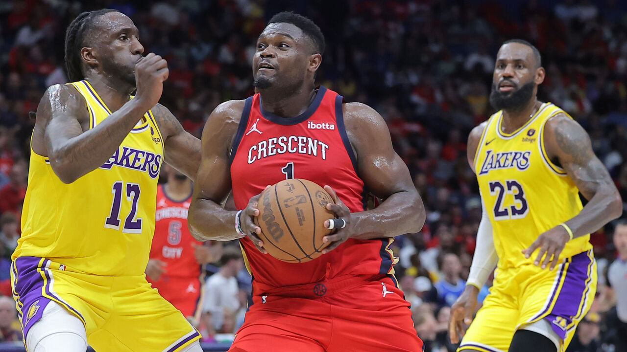 NEW ORLEANS, LOUISIANA - APRIL 16: Zion Williamson #1 of the New Orleans Pelicans drives against Taurean Prince #12 and LeBron James #23 of the Los Angeles Lakers during the first half of a game at the Smoothie King Center on April 16, 2024 in New Orleans, Louisiana.
