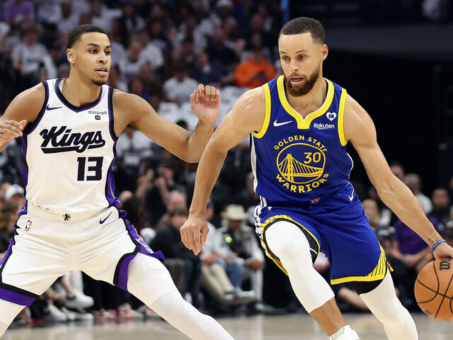 SACRAMENTO, CALIFORNIA - APRIL 16: Stephen Curry #30 of the Golden State Warriors is guarded by Keegan Murray #13 of the Sacramento Kings in the first quarter during the Play-In Tournament at Golden 1 Center on April 16, 2024 in Sacramento, California.