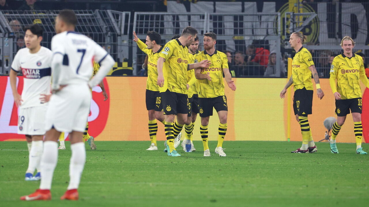 DORTMUND, GERMANY - DECEMBER 13: Karim Adeyemi #27 of Borussia Dortmunfd celebrate his first goal with teammates during the UEFA Champions League match between Borussia Dortmund and Paris Saint-Germain at Signal Iduna Park on December 13, 2023 in Dortmund, Germany.