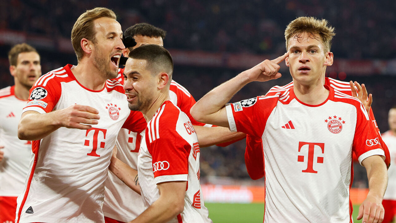 Bayern Munich's German midfielder #06 Joshua Kimmich (R) celebrates scoring the opening goal with his teammates including Bayern Munich's Portuguese defender #22 Raphael Guerreiro (C) and Bayern Munich's English forward #09 Harry Kane during the UEFA Champions League quarter-final second leg football match between FC Bayern Munich and Arsenal FC in Munich, southern Germany on April 17, 2024.