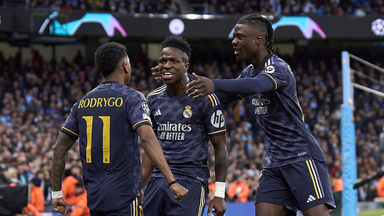 MANCHESTER, ENGLAND - APRIL 17: Rodrygo Silva De Goes of Real Madrid celebrates with Vinicius Junior (C) and Eduardo Camavinga (R) after scoring the first goal during the UEFA Champions League quarter-final second leg match between Manchester City and Real Madrid CF at Etihad Stadium on April 17, 2024 in Manchester, England.