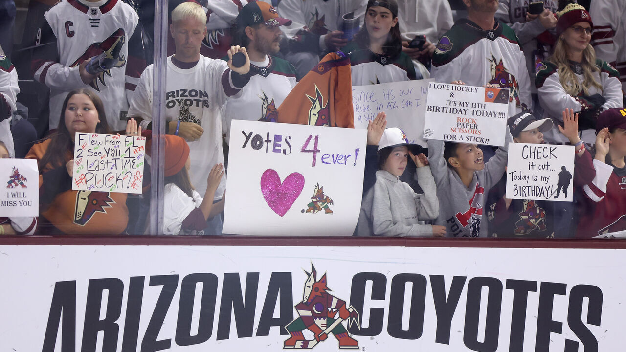 TEMPE, ARIZONA - APRIL 17: Fans hold up signs before the NHL game between the Edmonton Oilers and the Arizona Coyotes at Mullett Arena on April 17, 2024 in Tempe, Arizona. Tonight's game likely marks the end of 28 years for the franchise, playing in the NHL's smallest arena with an anticipated move to Utah with the team's expected sale to the NBA's Utah Jazz owner Ryan Smith.