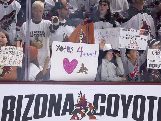 TEMPE, ARIZONA - APRIL 17: Fans hold up signs before the NHL game between the Edmonton Oilers and the Arizona Coyotes at Mullett Arena on April 17, 2024 in Tempe, Arizona. Tonight's game likely marks the end of 28 years for the franchise, playing in the NHL's smallest arena with an anticipated move to Utah with the team's expected sale to the NBA's Utah Jazz owner Ryan Smith.
