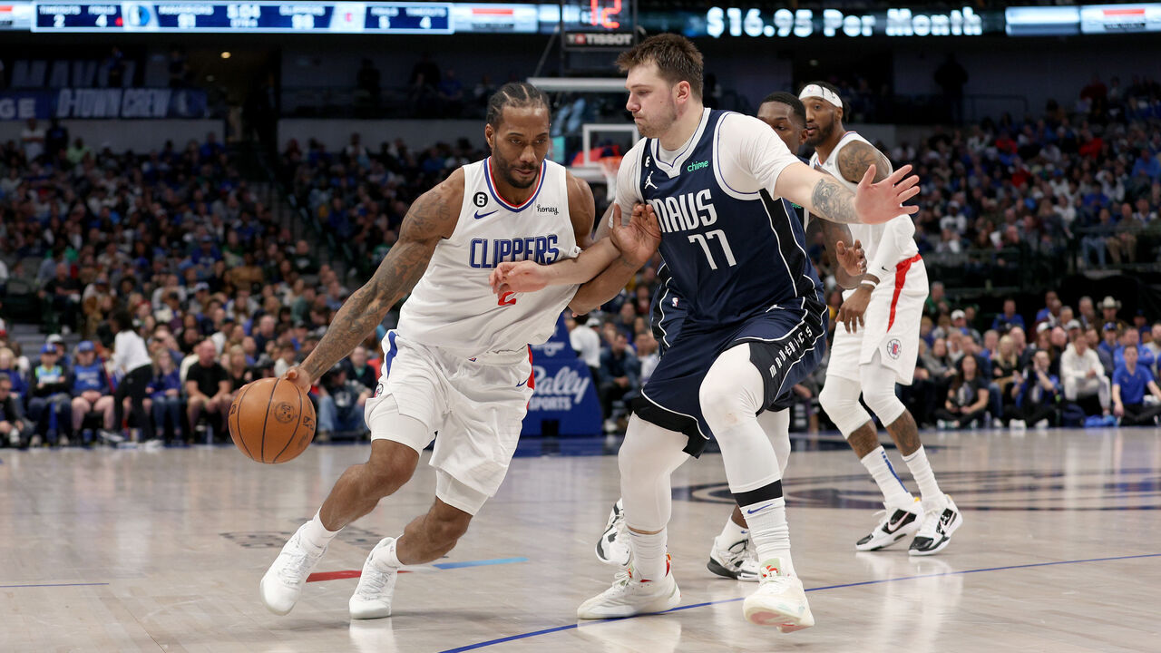 DALLAS, TEXAS - JANUARY 22: Kawhi Leonard #2 of the LA Clippers drives to the basket against Luka Doncic #77 of the Dallas Mavericks in the fourth quarter at American Airlines Center on January 22, 2023 in Dallas, Texas.