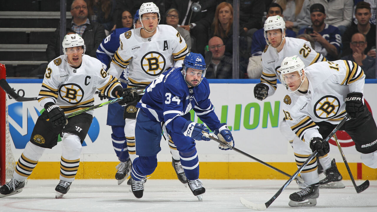 TORONTO, CANADA - MARCH 4: Auston Matthews #34 of the Toronto Maple Leafs keeps an eye on a high puck with Charlie Coyle #13 of the Boston Bruins during the first period in an NHL game at Scotiabank Arena on March 4, 2024 in Toronto, Ontario, Canada. The Bruins defeated the Maple Leafs 4-1.