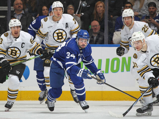 TORONTO, CANADA - MARCH 4: Auston Matthews #34 of the Toronto Maple Leafs keeps an eye on a high puck with Charlie Coyle #13 of the Boston Bruins during the first period in an NHL game at Scotiabank Arena on March 4, 2024 in Toronto, Ontario, Canada. The Bruins defeated the Maple Leafs 4-1.