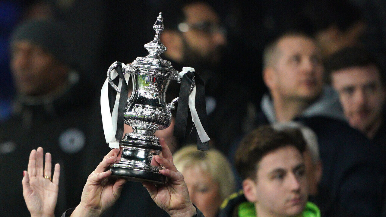 Boreham Wood fans in the stands hold up an FA Cup replica trophy before the Emirates FA Cup fifth round match at Goodison Park, Liverpool. Picture date: Thursday March 3, 2022.