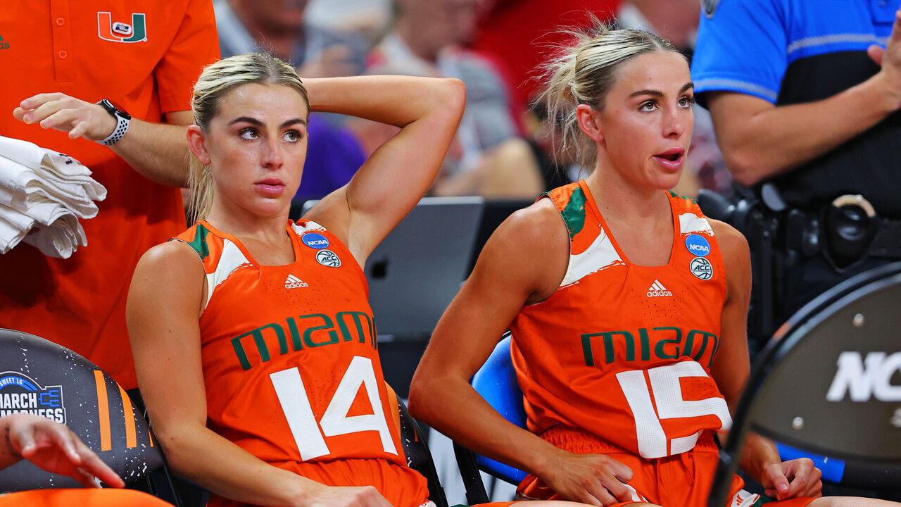 GREENVILLE, SOUTH CAROLINA - MARCH 24: Haley Cavinder #14 of the Miami Hurricanes and Hanna Cavinder #15 of the Miami Hurricanes sit on the bench during the second half against the Villanova Wildcats in the Sweet 16 round of the NCAA Women's Basketball Tournament at Bon Secours Wellness Arena on March 24, 2023 in Greenville, South Carolina.