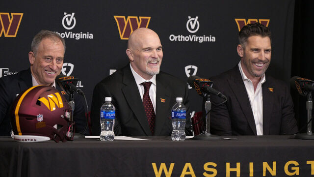 ASHBURN, VIRGINIA - FEBRUARY 05: Head coach Dan Quinn of the Washington Commanders speaks during a press conference alongside managing partner Josh Harris, left, and general manager Adam Peters at OrthoVirginia Training Center at Commanders Park on February 05, 2024 in Ashburn, Virginia.