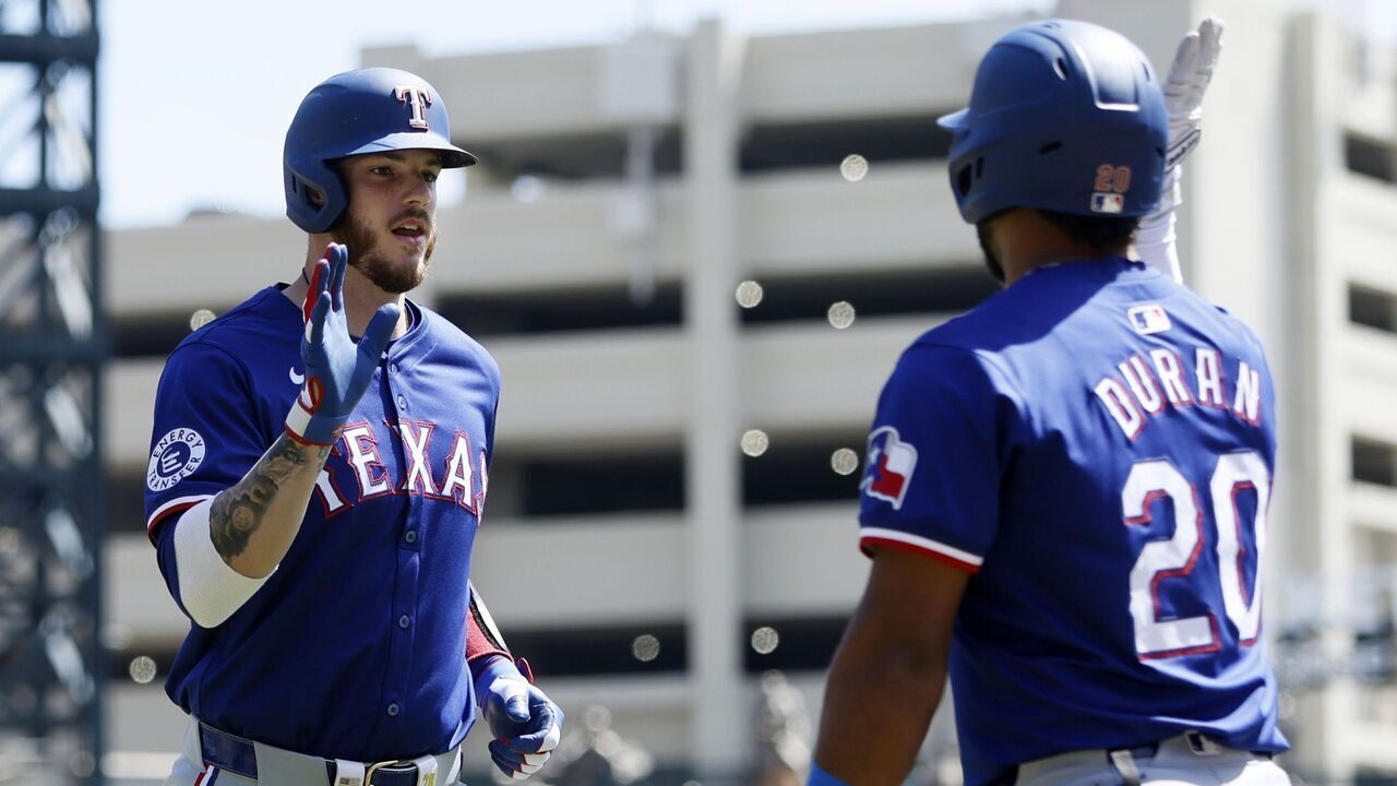 DETROIT, MI - APRIL 18: Jonah Heim #28 of the Texas Rangers celebrates with Ezequiel Duran #20 after hitting a two-run home run against the Detroit Tigers during the second inning at Comerica Park on April 18, 2024 in Detroit, Michigan.