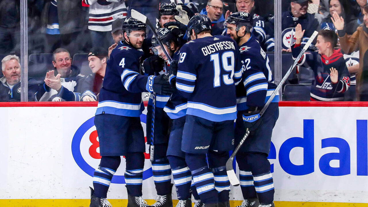 WINNIPEG, CANADA - APRIL 18: Neal Pionk #4, Dylan Samberg #54, Nikita Chibrikov #90, David Gustafsson #19 and Nino Niederreiter #62 of the Winnipeg Jets celebrate a third period goal against the Vancouver Canucks at the Canada Life Centre on April 18, 2024 in Winnipeg, Manitoba, Canada.