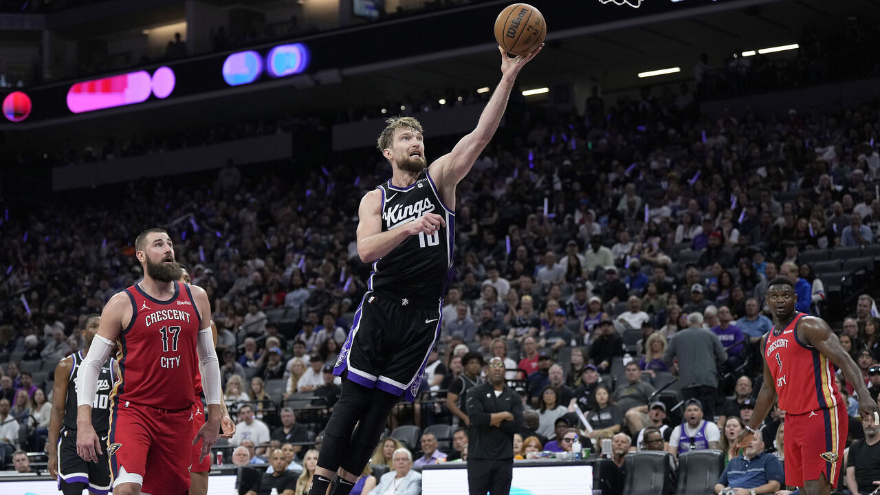 SACRAMENTO, CALIFORNIA - APRIL 11: Domantas Sabonis #10 of the Sacramento Kings shoots over a falling Herbert Jones #5 of the New Orleans Pelicans during the second half of an NBA basketball game at Golden 1 Center on April 11, 2024 in Sacramento, California.