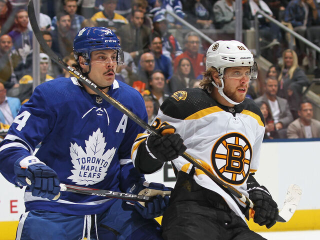 TORONTO, ON - OCTOBER 19: David Pastrnak #88 of the Boston Bruins skates against Auston Matthews #34 of the Toronto Maple Leafs during an NHL game at Scotiabank Arena on October 19, 2019 in Toronto, Ontario, Canada.