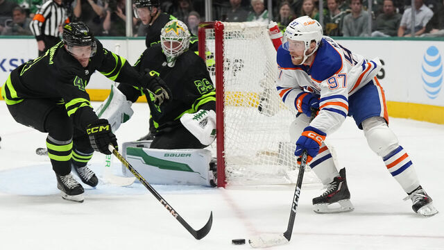 DALLAS, TEXAS - APRIL 03: Connor McDavid #97 of the Edmonton Oilers is defended by Miro Heiskanen #4 of the Dallas Stars during the second period at American Airlines Center on April 03, 2024 in Dallas, Texas.