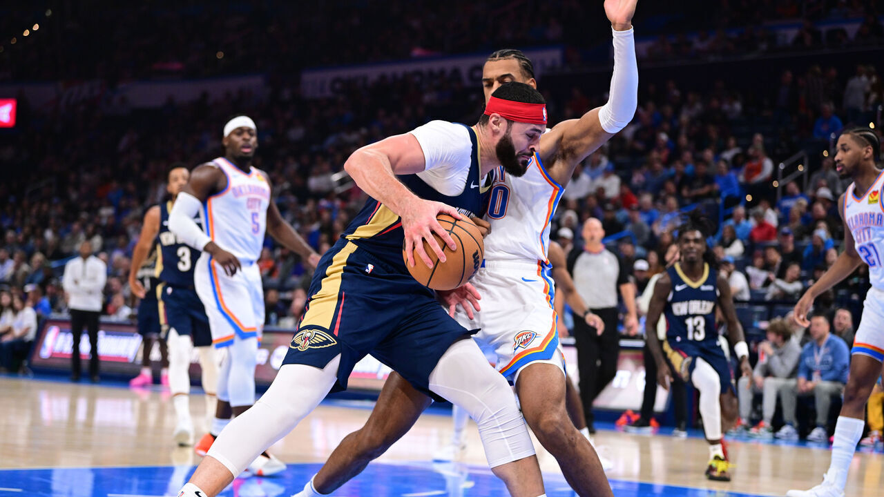 OKLAHOMA CITY, OKLAHOMA - NOVEMBER 1: Larry Nance Jr. #22 of the New Orleans Pelicans drives into the lane while being defended by Olivier Sarr #30 of the Oklahoma City Thunder during the first half at Paycom Center on November 1, 2023 in Oklahoma City, Oklahoma.