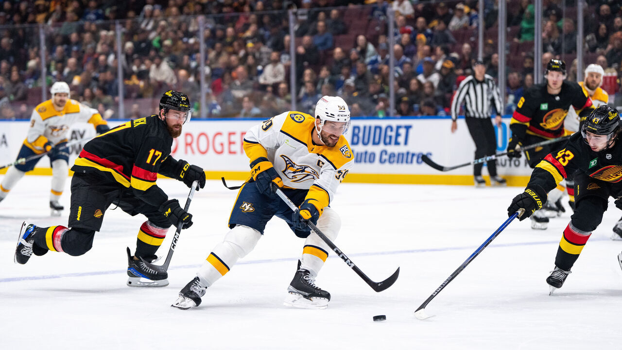 VANCOUVER, BC - OCTOBER 31: Nashville Predators defenseman Roman Josi (59) skates with the puck with Vancouver Canucks defenseman Filip Hronek (17) and defenseman Quinn Hughes (43) the Vancouver Canucks game versus the Nashville Predators on October 31, 2023, at Rogers Arena in Vancouver, B.C.