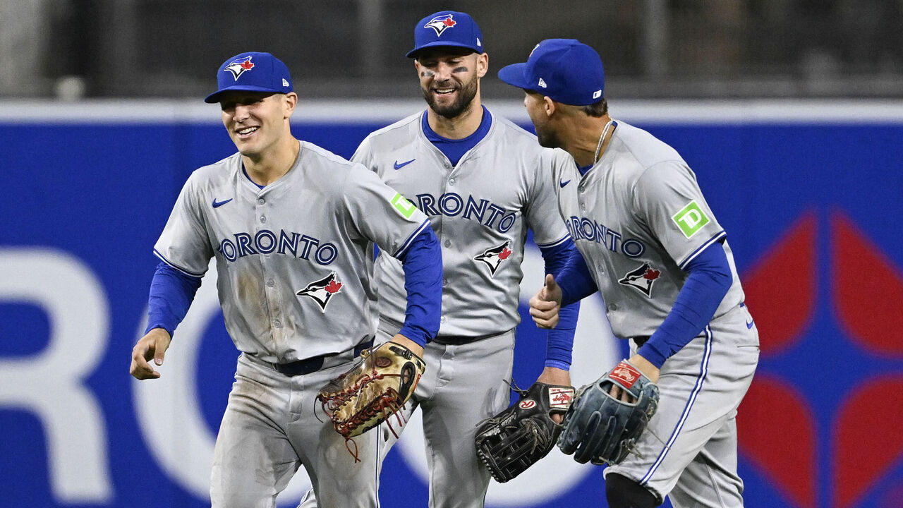 SAN DIEGO, CA - APRIL 20: Daulton Varsho #25 of the Toronto Blue Jays, left, Kevin Kiermaier #39, center, and George Springer #4 celebrate after the Blue Jays beat the San Diego Padres 5-2 in a baseball game on April 20, 2024 at Petco Park in San Diego, California.