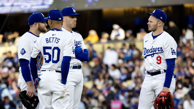 LOS ANGELES, CA - APRIL 14, 2024: Dodgers infielders Gavin Lux (9), Mookie Bets (50), Max Muncy (13) and Freddie Freeman chat while a new relief pitcher warms up during the game against the San Diego Padres at Dodger Stadium on April 14, 2024 in Los Angeles, California.(Gina Ferazzi / Los Angeles Times via Getty Images)