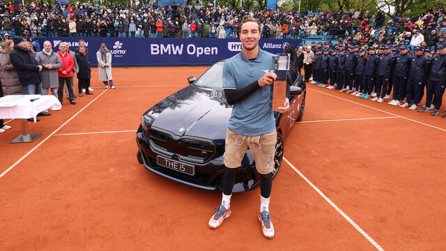 MUNICH, GERMANY - APRIL 21: Jan-Lennard Struff of Germany poses next to his winners car BMW i5 after winning his final match against Taylor Fritz of the USA during day 9 of the BMW Open at MTTC IPHITOS on April 21, 2024 in Munich, Germany.
