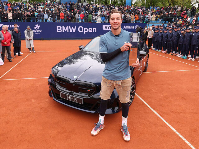 MUNICH, GERMANY - APRIL 21: Jan-Lennard Struff of Germany poses next to his winners car BMW i5 after winning his final match against Taylor Fritz of the USA during day 9 of the BMW Open at MTTC IPHITOS on April 21, 2024 in Munich, Germany.