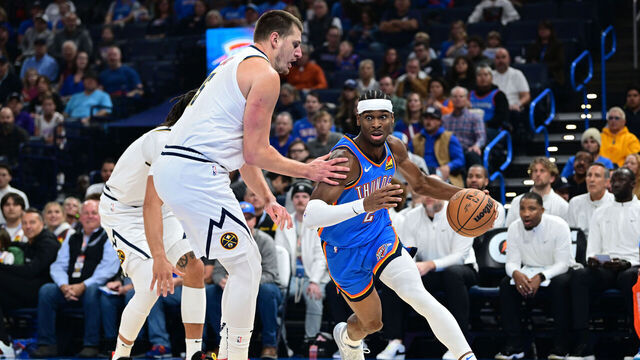 OKLAHOMA CITY, OKLAHOMA - OCTOBER 29: Shai Gilgeous-Alexander #2 of the Oklahoma City Thunder attempts to drive past Nikola Jokic #15 of the Denver Nuggets during the first quarter of a game at Paycom Center on October 29, 2023 in Oklahoma City, Oklahoma.