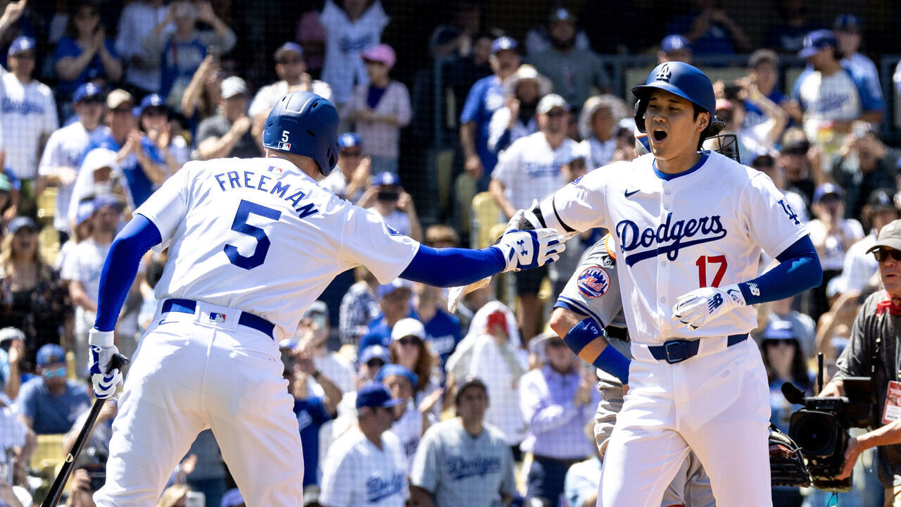 LOS ANGELES, CA - APRIL 21, 2024: Los Angeles Dodgers designated hitter player Shohei Ohtani (17) gets congrats from Los Angeles Dodgers first base Freddie Freeman (5) after hitting a 2-run homer against the New York Mets in the third inning at Dodger Stadium on April 21, 2024 in Los Angeles, California.(Gina Ferazzi / Los Angeles Times via Getty Images)