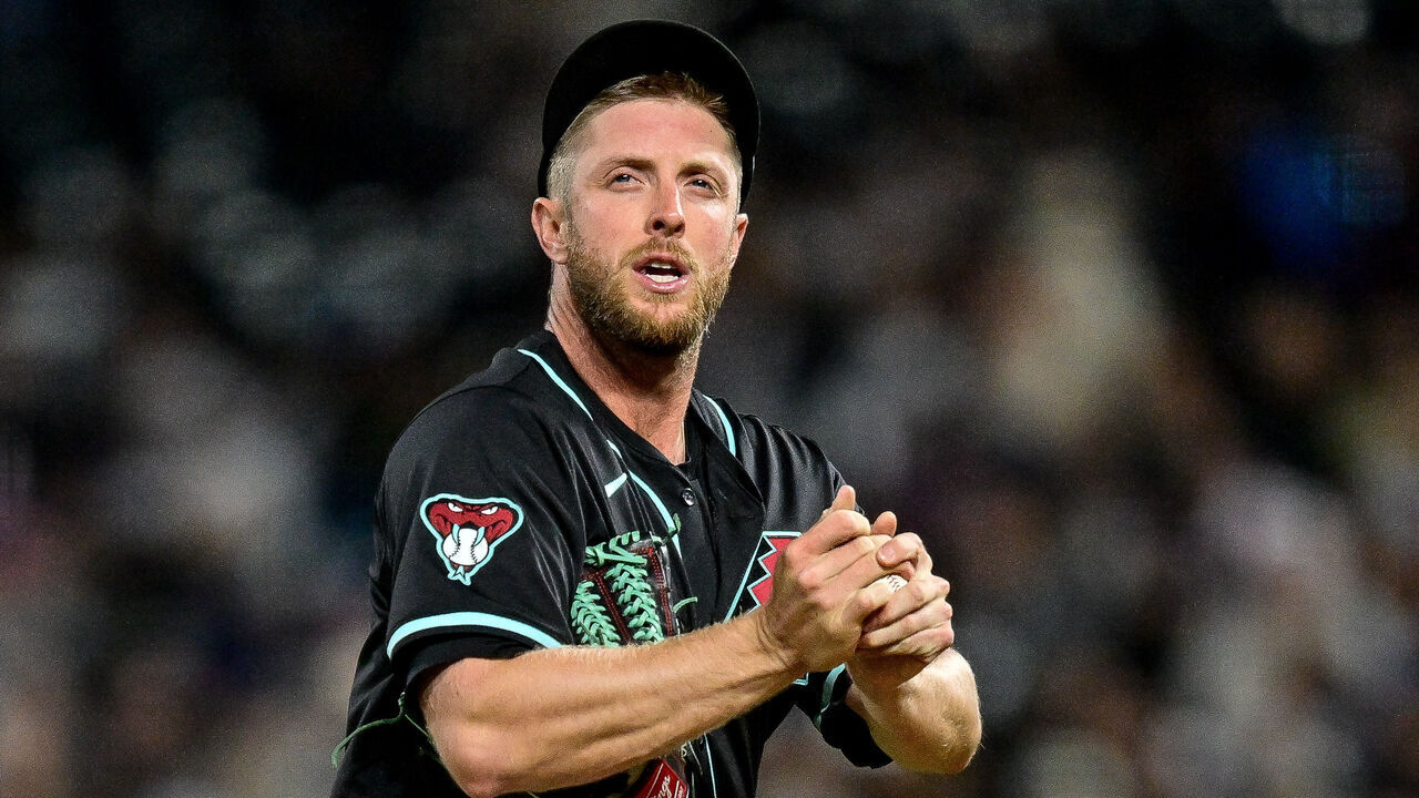 DENVER, CO - APRIL 09: Arizona Diamondbacks starting pitcher Merrill Kelly (29) looks on as he pitches during a game between the Arizona Diamondbacks and the Colorado Rockies at Coors Field on April 9, 2024 in Denver, Colorado.