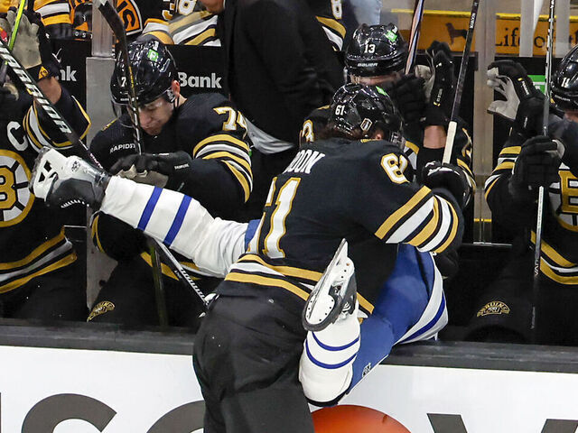 Boston, MA - April 20: Boston Bruins left wing Pat Maroon checks Toronto Maple Leafs defenseman Timothy Liljegren into the Bruins bench in the first period.