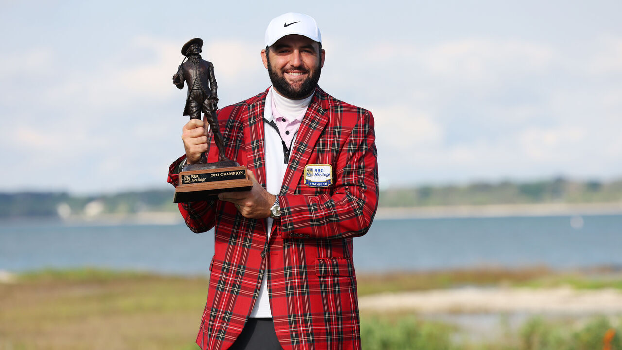 HILTON HEAD ISLAND, SOUTH CAROLINA - APRIL 22: Scottie Scheffler of the United States celebrates with the trophy and the tartan jacket after winning during the continuation of the final round of the RBC Heritage at Harbour Town Golf Links on April 22, 2024 in Hilton Head Island, South Carolina.