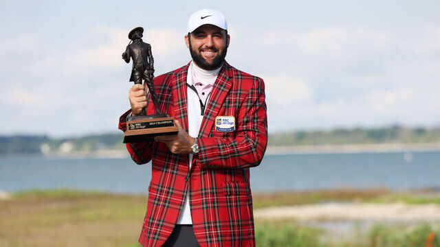 HILTON HEAD ISLAND, SOUTH CAROLINA - APRIL 22: Scottie Scheffler of the United States celebrates with the trophy and the tartan jacket after winning during the continuation of the final round of the RBC Heritage at Harbour Town Golf Links on April 22, 2024 in Hilton Head Island, South Carolina.