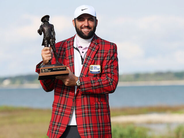 HILTON HEAD ISLAND, SOUTH CAROLINA - APRIL 22: Scottie Scheffler of the United States celebrates with the trophy and the tartan jacket after winning during the continuation of the final round of the RBC Heritage at Harbour Town Golf Links on April 22, 2024 in Hilton Head Island, South Carolina.