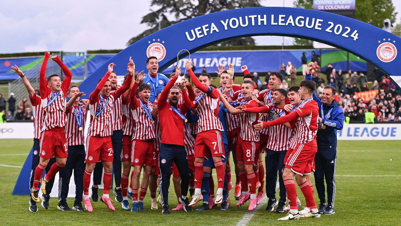NYON, SWITZERLAND - APRIL 22: Olympiacos captain Athanasios Koutsogoulas, 7, celebrates with the Lennart Johansson Trophy and team-mates during the UEFA Youth League 2023/24 Final match between Olympiacos and AC Milan at Centre Sportif de Colovray on April 22, 2024 in Nyon, Switzerland.