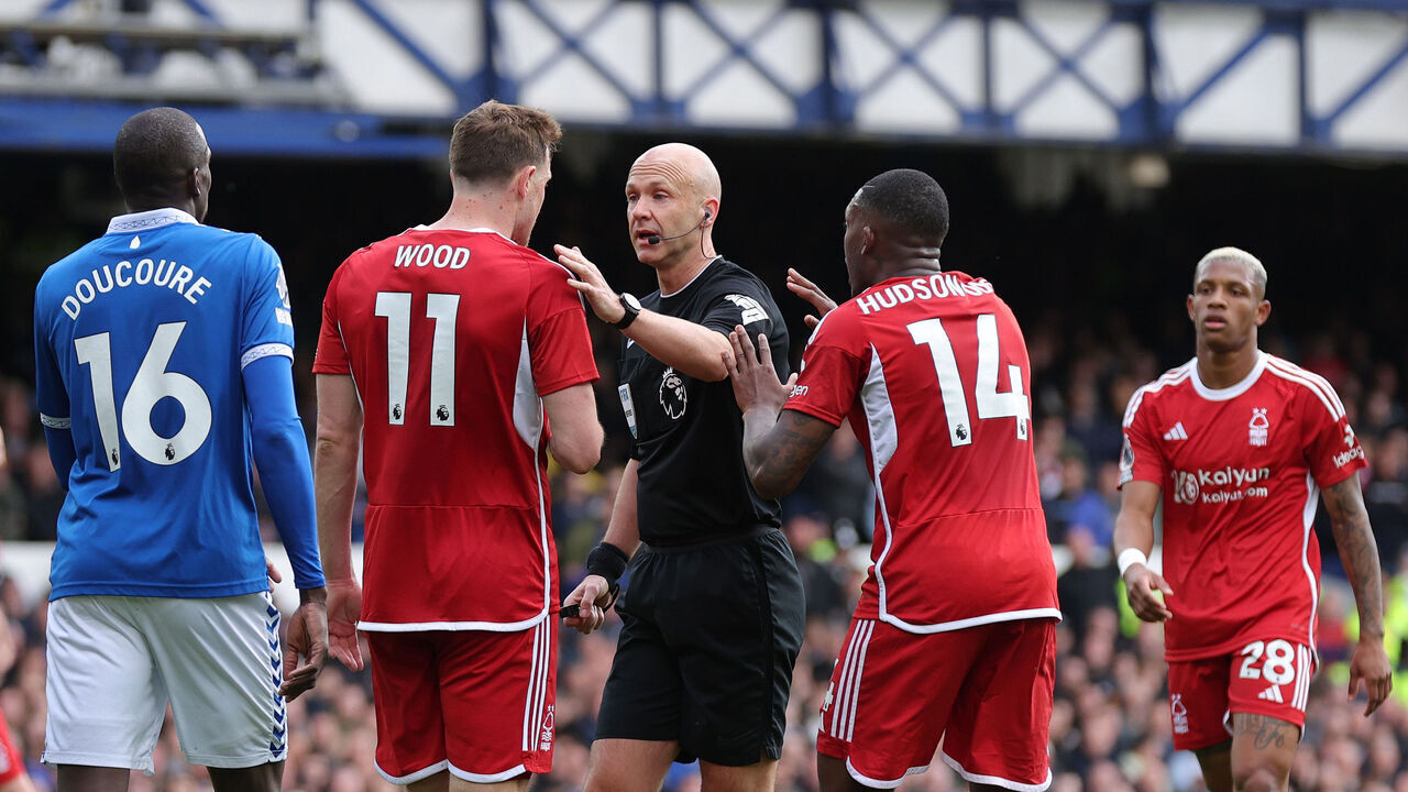 LIVERPOOL, ENGLAND - APRIL 21: Referee Anthony Taylor is confronted by Chris Wood and Callum Hudson-Odoi of Nottingham Forest claiming a hand ball against Ashley Young of Everton (not pictured) during the Premier League match between Everton FC and Nottingham Forest at Goodison Park on April 21, 2024 in Liverpool, England.