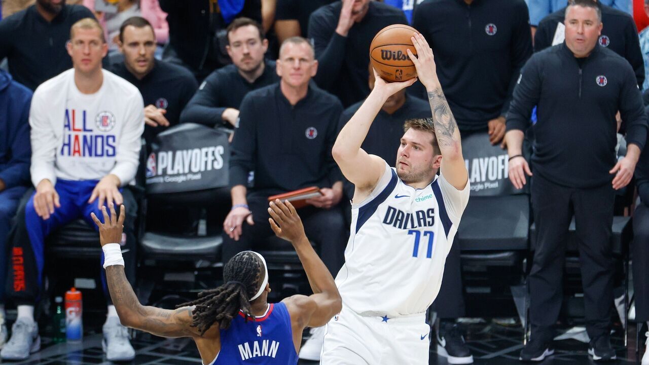 Dallas Mavericks' Luka Doncic R shoots against Los Angeles Clippers' Terance Mann during the NBA first-round playoff match between Los Angeles Clippers and Dallas Mavericks in Los Angeles, the United States, April 21, 2024.