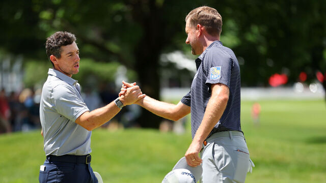 CROMWELL, CONNECTICUT - JUNE 23: Rory McIlroy of Northern Ireland shakes hands with Webb Simpson of the United States as they finish their round on the ninth green during the first round of Travelers Championship at TPC River Highlands on June 23, 2022 in Cromwell, Connecticut.
