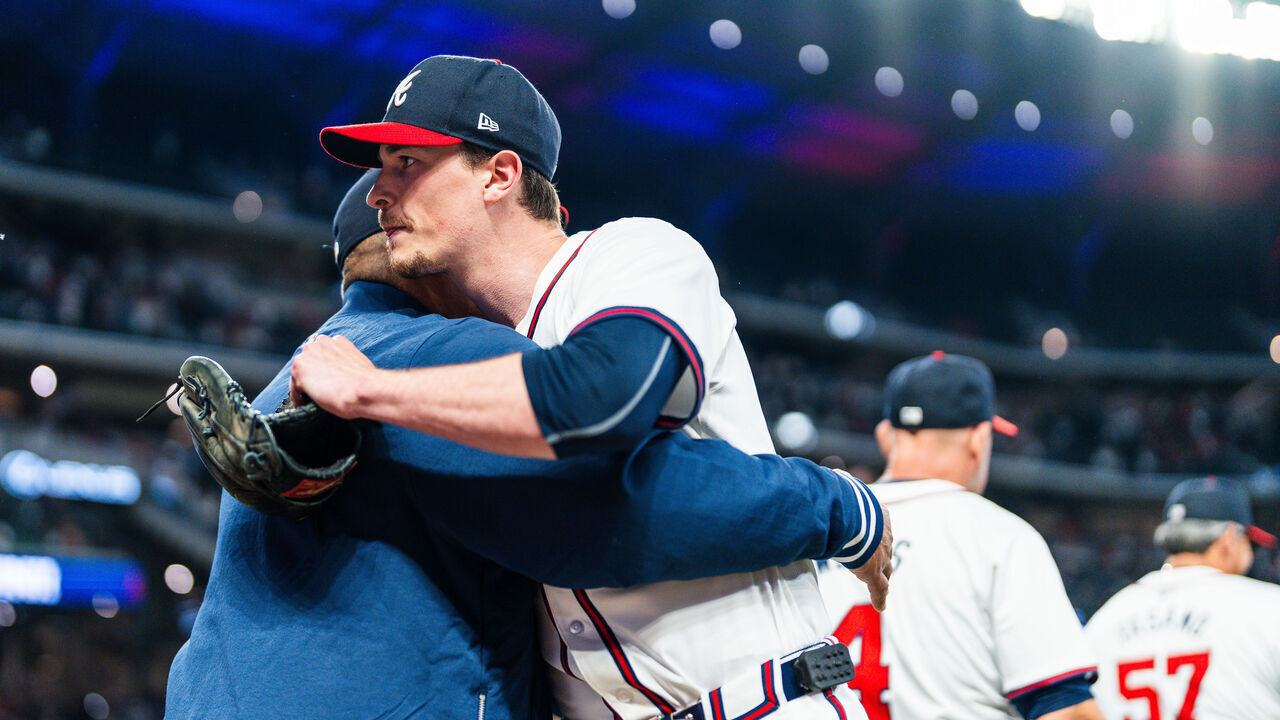 ATLANTA, GA - APRIL 23: Max Fried #54 hugs Eddie Pérez #95 of the Atlanta Braves after the game against the Miami Marlins at Truist Park on April 23, 2024 in Atlanta, Georgia. Fried pitched a complete game shutout in 92 pitches as the Atlanta Braves defeated the Miami Marlins 5-0.