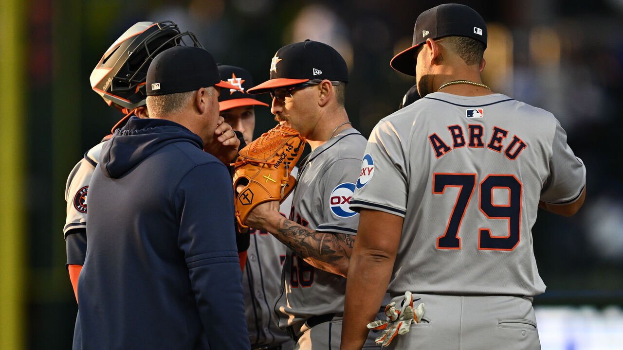 CHICAGO, IL - APRIL 23: J.P. France #68 of the Houston Astros, center, talks with a coach and infielders during the first inning against the Chicago Cubs at Wrigley Field on April 23, 2024 in Chicago, Illinois.