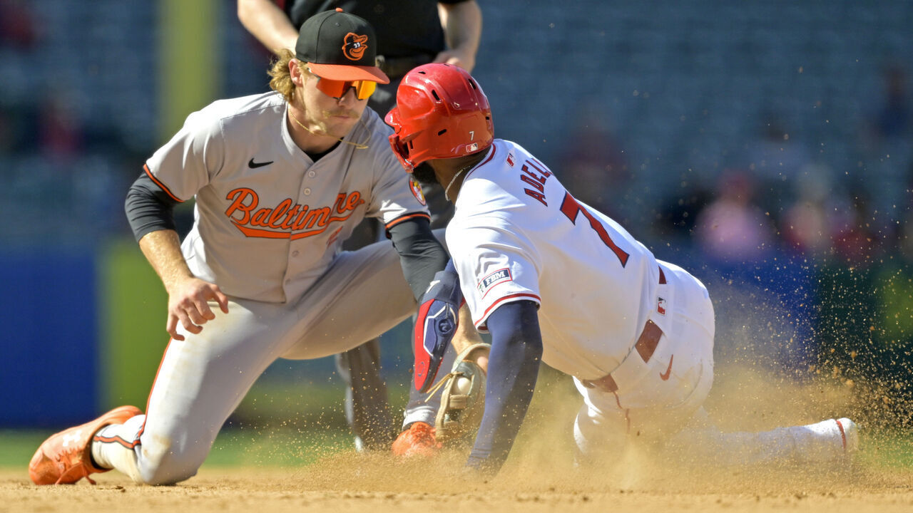 ANAHEIM, CALIFORNIA - APRIL 24: After a review of the play Jo Adell #7 of the Los Angeles Angels is caught stealing on a tag by Gunnar Henderson #2 of the Baltimore Orioles in the ninth inning at Angel Stadium of Anaheim on April 24, 2024 in Anaheim, California.