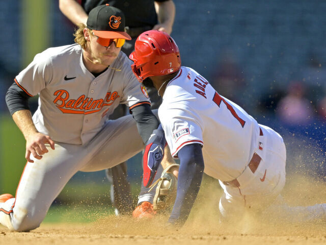 ANAHEIM, CALIFORNIA - APRIL 24: After a review of the play Jo Adell #7 of the Los Angeles Angels is caught stealing on a tag by Gunnar Henderson #2 of the Baltimore Orioles in the ninth inning at Angel Stadium of Anaheim on April 24, 2024 in Anaheim, California.