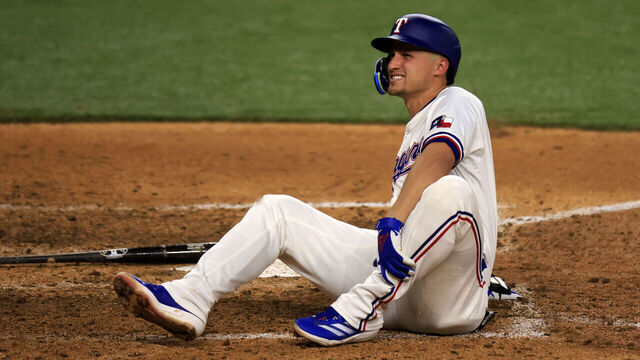 ARLINGTON, TX - APRIL 24: Corey Seager #5 of the Texas Rangers reacts after being hit by a pitch against the Seattle Mariners during the seventh inning at Globe Life Field on April 24, 2024 in Arlington, Texas.