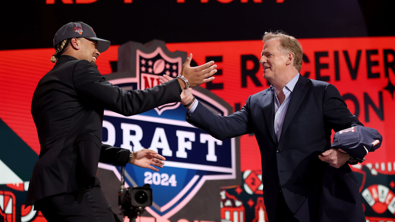 DETROIT, MICHIGAN - APRIL 25: (L-R) Rome Odunze shakes hands with NFL Commissioner Roger Goodell after being selected ninth overall by the Chicago Bears during the first round of the 2024 NFL Draft at Campus Martius Park and Hart Plaza on April 25, 2024 in Detroit, Michigan.