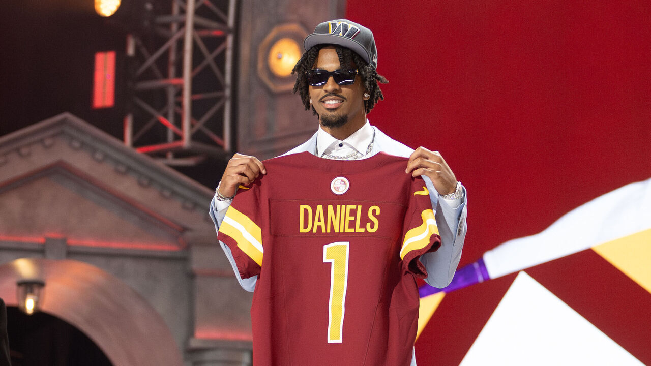 DETROIT, MI - APRIL 25: Washington Commanders Quarterback Jayden Daniels poses with a jersey after being picked second overall during day 1 of the NFL Draft on April 25, 2024 at Fox Theatre in Detroit, MI.