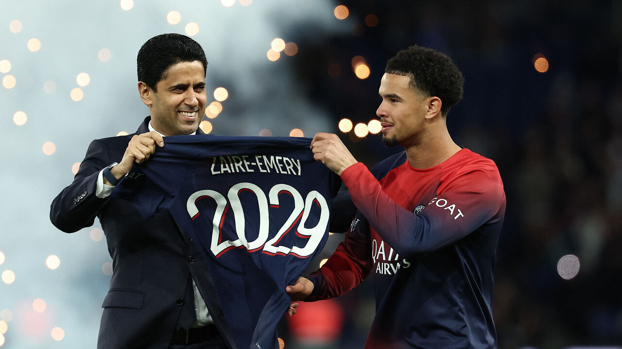 Paris Saint Germain's Qatari president Nasser al-Khelaifi (L) poses with Paris Saint-Germain's French midfielder #33 Warren Zaire-Emery during a ceremony marking the prolongation of the player's contract ahead of the French L1 football match between Paris Saint-Germain (PSG) and Le Havre AC at the Parc des Princes Stadium in Paris on April 27, 2024.
