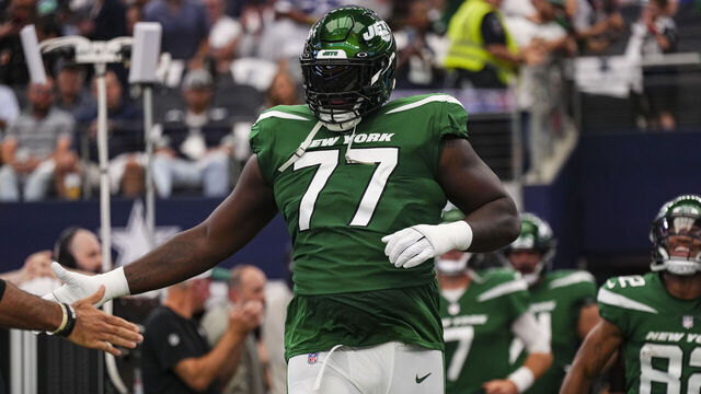 ARLINGTON, TX - SEPTEMBER 17: Mekhi Becton #77 of the New York Jets runs out onto the field prior to a football game at AT&T Stadium on September 17, 2023 in Arlington, Texas.