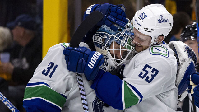 NASHVILLE, TENNESSEE - APRIL 28: Arturs Silovs #31 and Teddy Blueger #53 of the Vancouver Canucks celebrate after defeating the Nashville Predators during overtime of Game Four of the First Round of the 2024 Stanley Cup Playoffs at Bridgestone Arena on April 28, 2024 in Nashville, Tennessee.