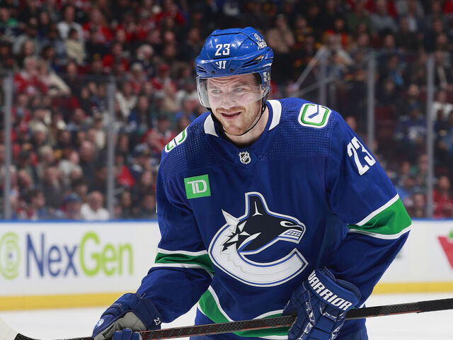 VANCOUVER, CANADA - MARCH 21: Elias Lindholm #23 of the Vancouver Canucks lines up for a face off during their NHL game against the Montréal Canadiens at Rogers Arena on March 21, 2024 in Vancouver, British Columbia, Canada.